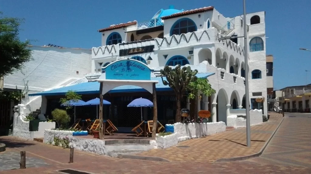 Colorful façade of Casa Blanca Hotel facing the harbor in San Cristóbal.