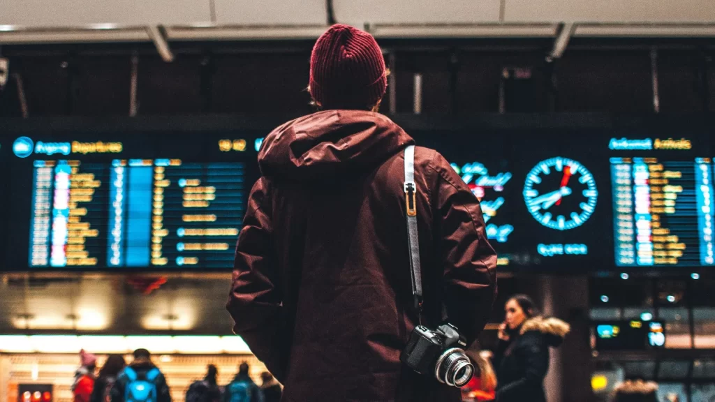 Tourist carefully checks the timetable, ready to decide on his next destination-LAX to Galápagos