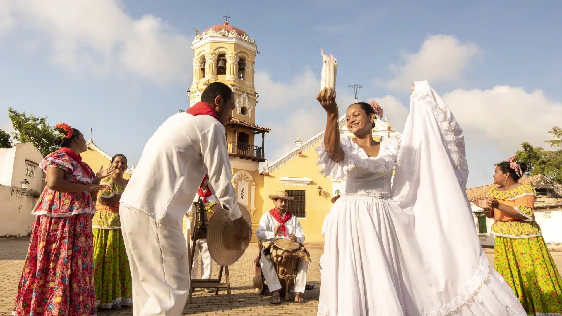 Traditional dancers performing cumbia in Mompox, Colombia, in front of a colonial church