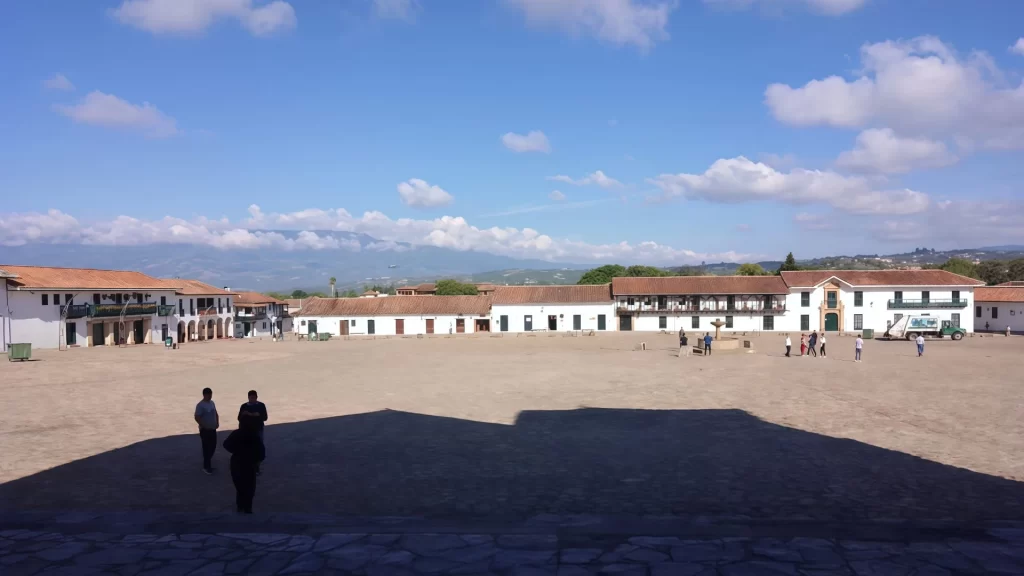 Wide view of the Plaza Mayor in Villa de Leyva, surrounded by white houses- Villa de Leyva culture