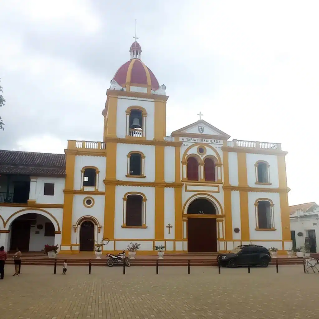 Façade of the Church of the Immaculate Conception in Santa Cruz de Mompox, Colombia, with colonial white and yellow detailing