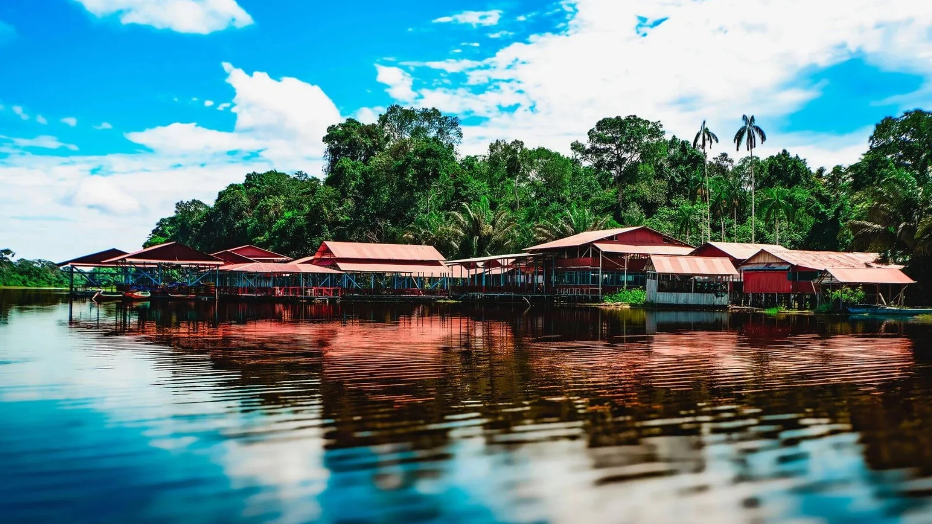 Marasha cabins reflected in an Amazonian lake-tourism in Colombia’s Amazon